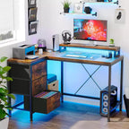 Scrivania da gioco Acekool a L con luci a LED, prese di corrente, cassetti e ripiani, scrivania ad angolo per ufficio domestico, nera