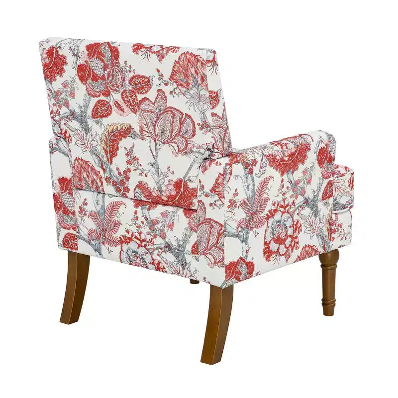 Poltrona di design Zeus & Ruta con rivestimento floreale, borchie e gambe in legno massello