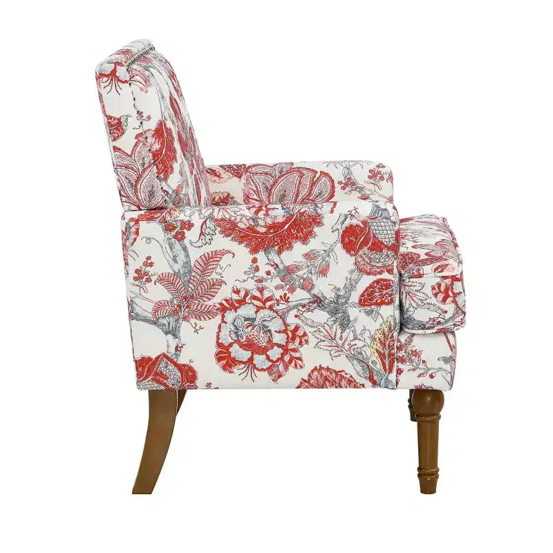 Poltrona di design Zeus & Ruta con rivestimento floreale, borchie e gambe in legno massello