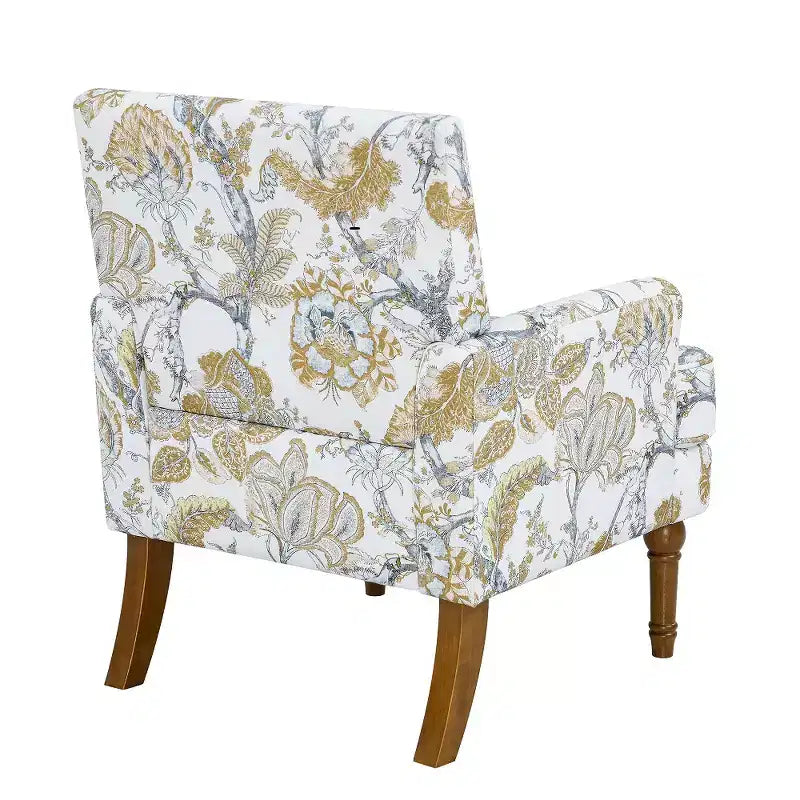 Poltrona di design Zeus & Ruta con rivestimento floreale, borchie e gambe in legno massello