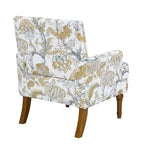 Poltrona di design Zeus & Ruta con rivestimento floreale, borchie e gambe in legno massello