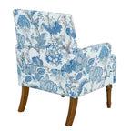 Poltrona di design Zeus & Ruta con rivestimento floreale, borchie e gambe in legno massello